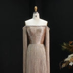 Full-length gold beaded gown with fitted bodice and dramatic fringe skirt