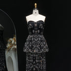 Full-length black beaded gown with layered peplum waist and column silhouette