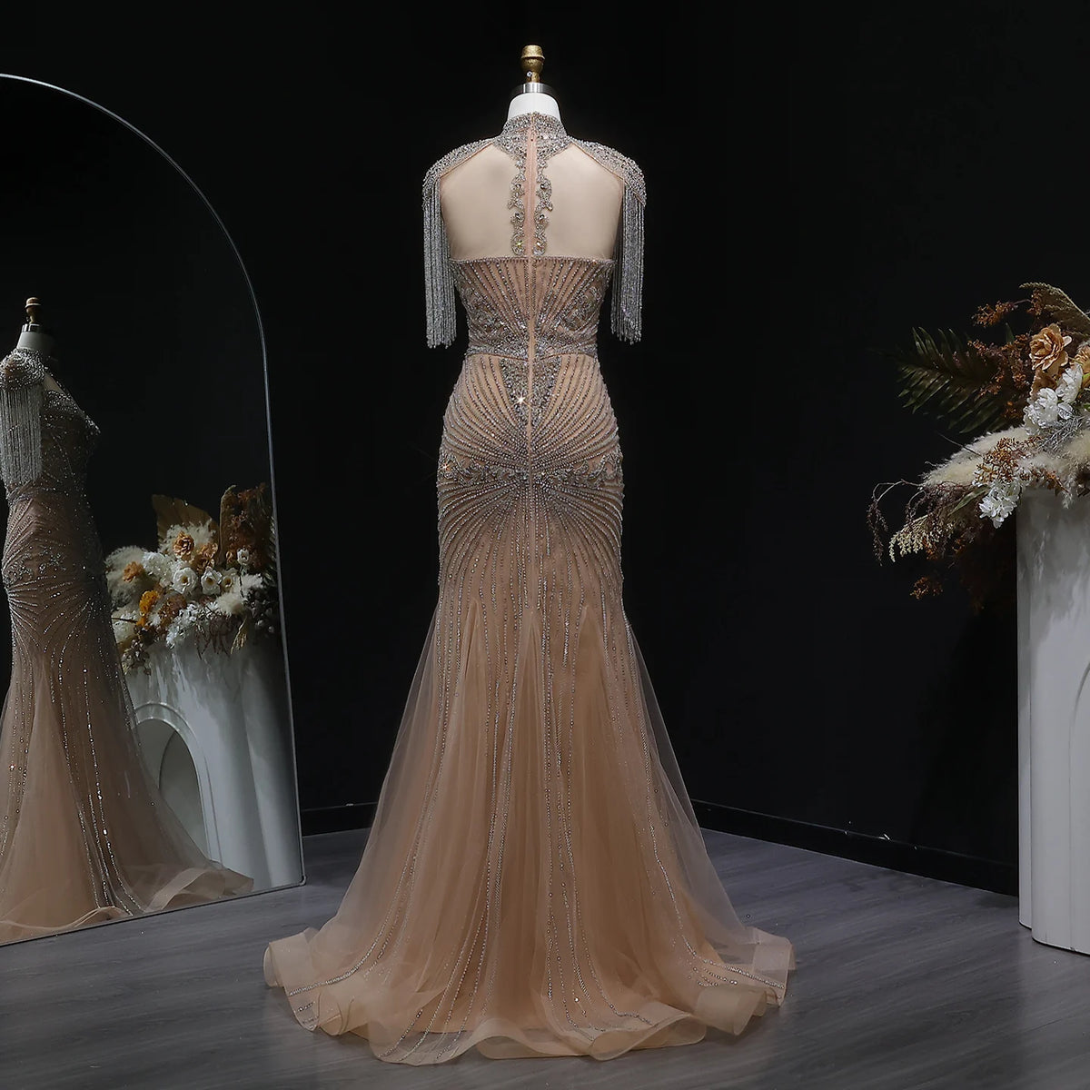 Back view of champagne crystal embellished mermaid evening gown with tulle skirt