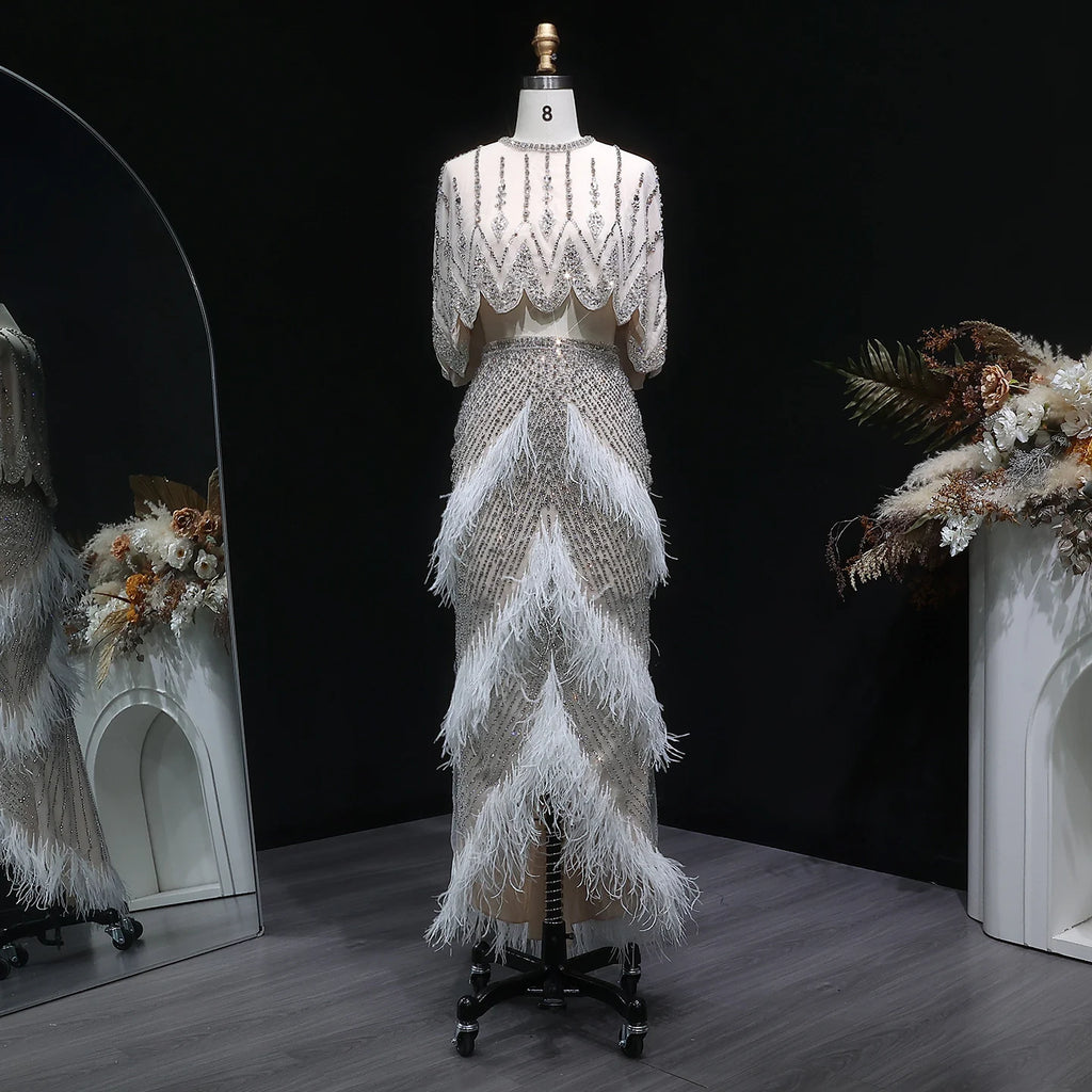 Front view of white beaded feather gown with fitted floor-length silhouette