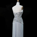 Silver luxury formal gown with dimensional beadwork and floor-length tassel fringe