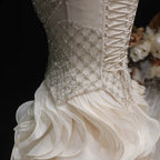 Beige embellished evening gown with fitted bodice and voluminous tulle skirt