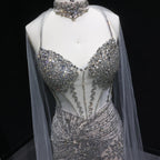 Close-up of silver formal gown with intricate crystal bead and sequin detailing