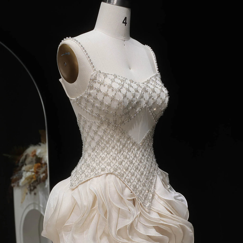 Beige formal gown with fitted embellished bodice and dramatic A-line silhouette