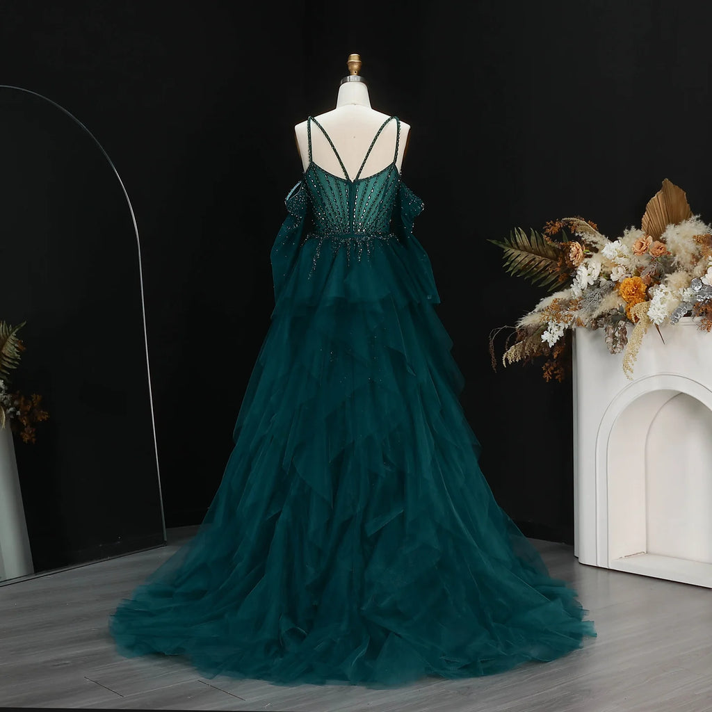 Back view of emerald green formal gown with floor-length ruffled tulle train